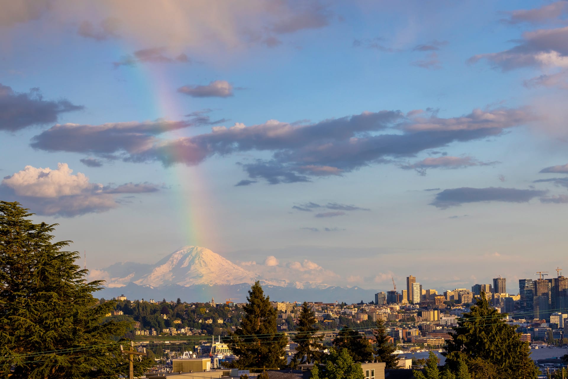 Rainbow arcing over Mount Rainier as seen from the rooftop patio
